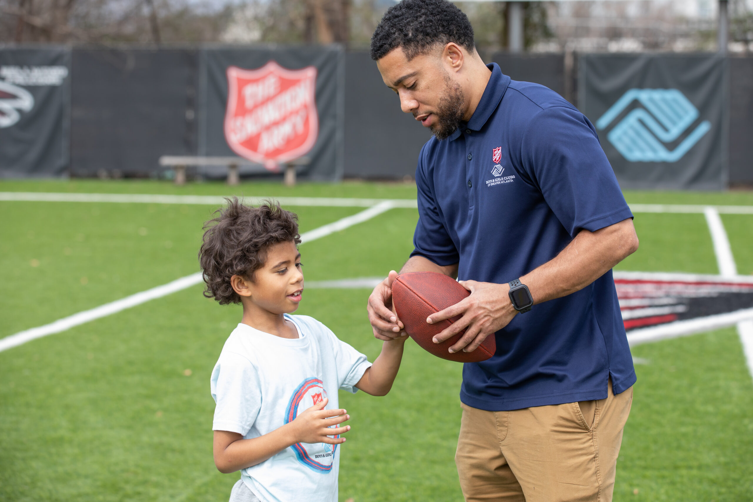 Boy and Man Playing Football